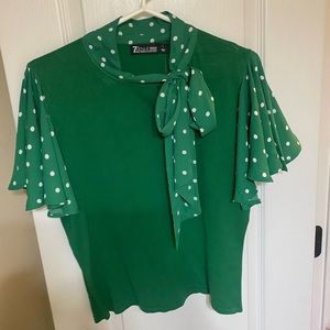 Green sweater blouse with neck tie.